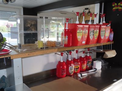 many red containers on the counter in the kitchen