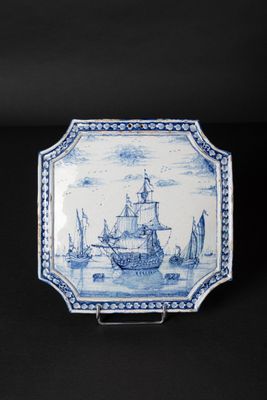 an old blue and white plate with a ship on it