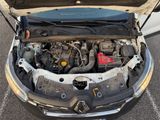 the engine of a car with its hood open in a parking lot