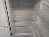 an open refrigerator with its door open in a kitchen