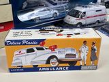two toy ambulances sitting on a table next to each other