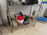 a metal shelf with tools on it in a kitchen