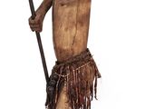 wooden statue of a man with a spear and a hat