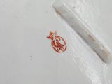 a white plate with a red design on it