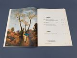 an open book with a picture of a woman walking in the woods