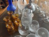 a table with a lot of glasses and a pitcher on it