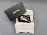 chanel shoes in a black box on a grey surface