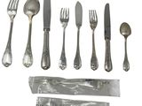 a set of silverware including a knife, fork, spoon, and spoon rest