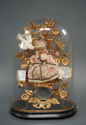 a glass dome with a figurine inside of it