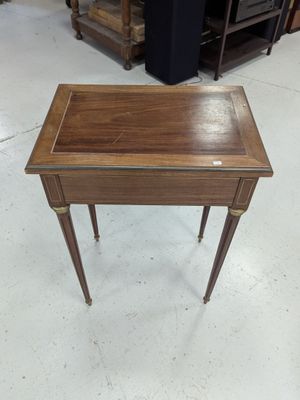 a small wooden table with a drawer on top of it