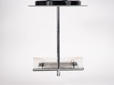 a black and white photo of a bird feeder on a pole