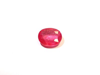 an image of a close up of a red stone on a white surface