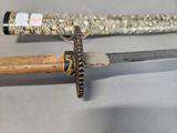 a close up of a knife with a wooden handle