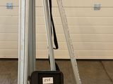 a tripod and a camera on a tripod in front of a garage door