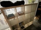a shelf with books and a bag on top of it