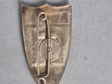 a small metal object with a hook on it