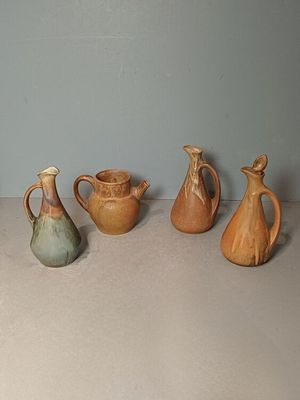 five different types of vases sitting on a table