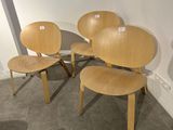 three wooden chairs and a table in a room with a window