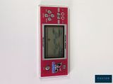 a picture of a red electronic device on a white wall