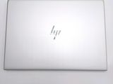 the back of a laptop computer sitting on top of a white table