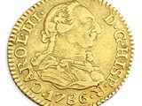 a close up of a gold coin on a white surface