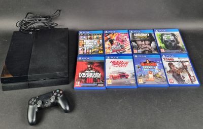 a lot of video games and a game controller on the table