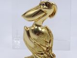 gold plated pelican figurine in a clear acrylic display case