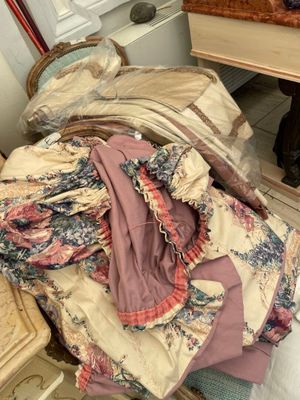 a pile of clothes sitting on a chair in a room