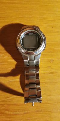 a watch that is sitting on a wooden table