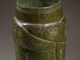 a green vase with a snake wrapped around it