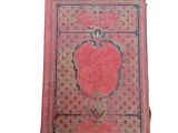 an old book with a red cover on a white background