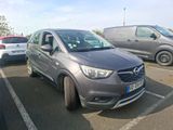 a grey car parked in a parking lot next to other cars
