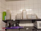 many plastic containers on the shelf in the kitchen
