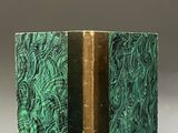 an old book with a green cover sitting on top of a table
