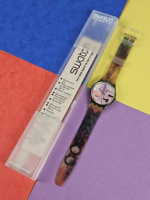a watch that is sitting on a colorful surface