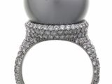 an image of a pearl and diamond ring on a white background