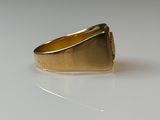 an image of a gold ring sitting on top of a white surface