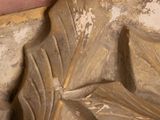 a close up of a statue of a man holding a book