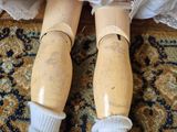 a doll that is sitting on a rug on the floor