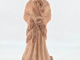 statue of a woman holding a basket of flowers on a wooden base