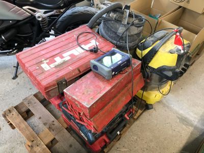 a red box sitting on top of a pallet next to a motorcycle