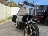 a motorcycle that is parked next to a car