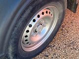 a close up of a truck tire on a gravel road