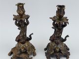 pair of antique bronze candlesticks with cherenshes and cherenshes