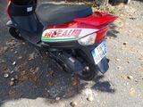 a scooter that is parked on the side of the road