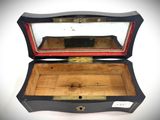 a small wooden box with a mirror inside of it