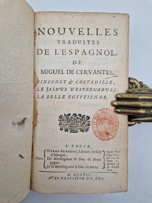 an open book with a key on top of it sitting on a table
