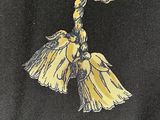 a close up of a tie with a tassel on it