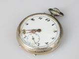 a silver pocket watch on a white surface