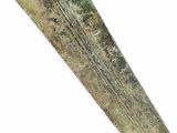an old, green and brown knife with a long blade sticking out of it ' s side